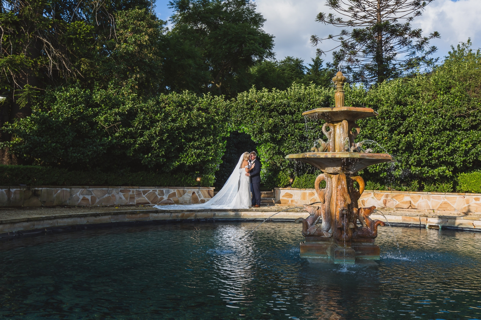 Natalie and Jason walking together through the grounds at Burnham Grove Estate