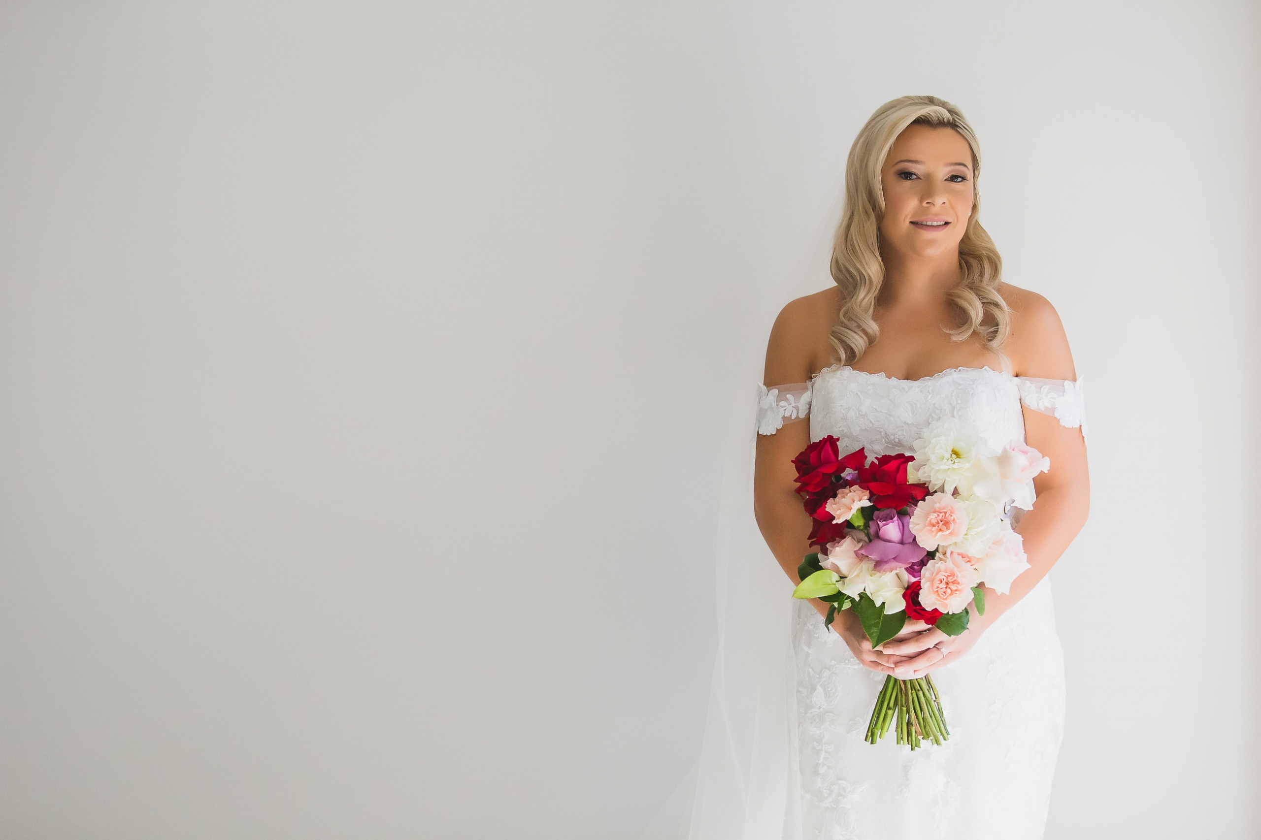A bride in window light before her wedding